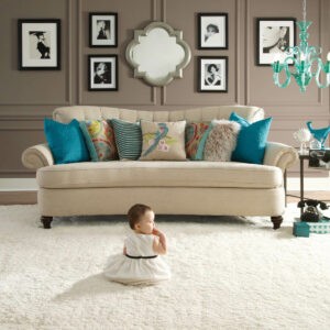 Cute baby sitting on carpet floor | Star Flooring & Design