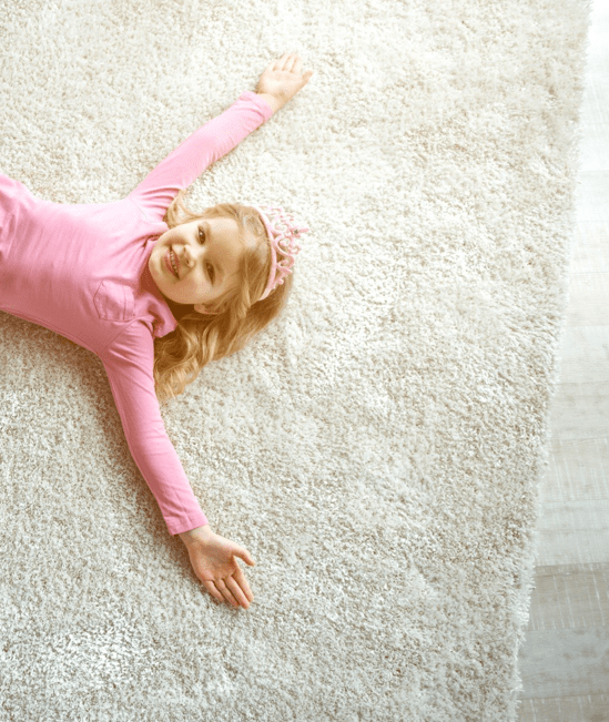 Cute girl laying on rug | Star Flooring & Design