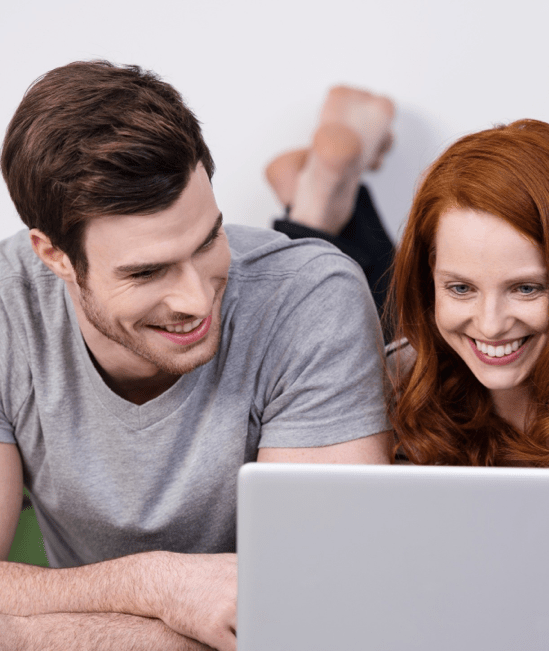 Happy couple with laptop | Star Flooring & Design